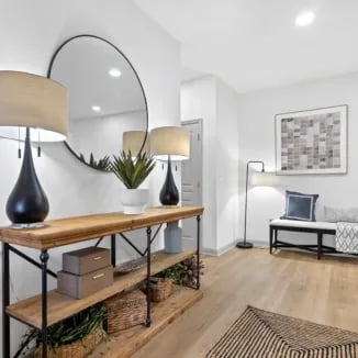 Entryway with console table mirrors artwork bench living area at Bellamy Milledgeville in Milledgeville Student Accommodation