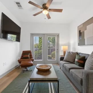 Sofa chair coffee table and TV living room at Bellamy Milledgeville in Milledgeville Student Accommodation