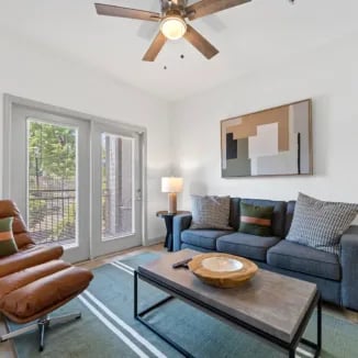 Modern living room with sofa chair and art living room at Bellamy Milledgeville in Milledgeville Student Accommodation