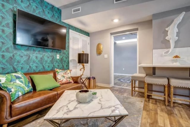Brown sofa patterned wallpaper marble coffee table living room at 61 Vandy in Charleston Student Accommodation