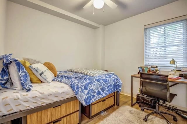 Bed with patterned bedding desk chair and lamp bedroom at 61 Vandy in Charleston Student Accommodation
