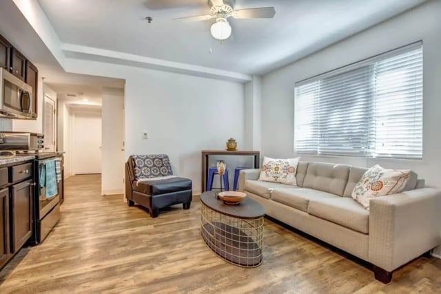 Sofa armchair coffee table kitchen living room at 61 Vandy in Charleston Student Accommodation