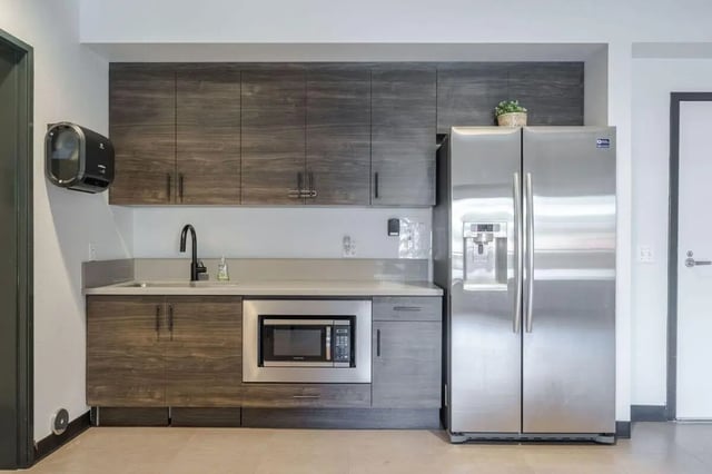 Stainless steel refrigerator microwave sink cabinets kitchen at Claremont Collegiate Apartments