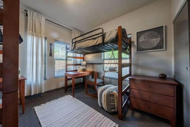 Loft bed desk chair dresser rug bedroom at Claremont Collegiate Apartments