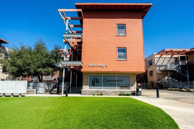 Orange building with windows and balconies exterior at Claremont Collegiate Apartments