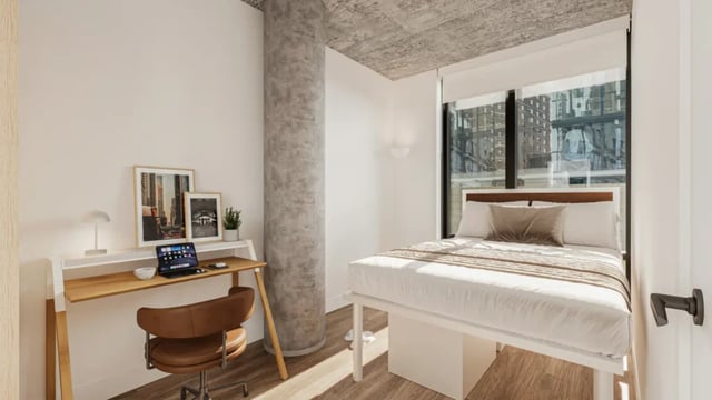 Desk bed and city view bedroom at 626 on the Park in Chicago Student Accommodation