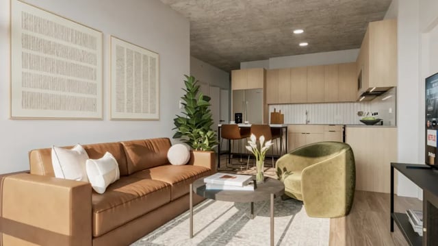 Sofa artworks plant chairs and kitchen living room at 626 on the Park in Chicago Student Accommodation