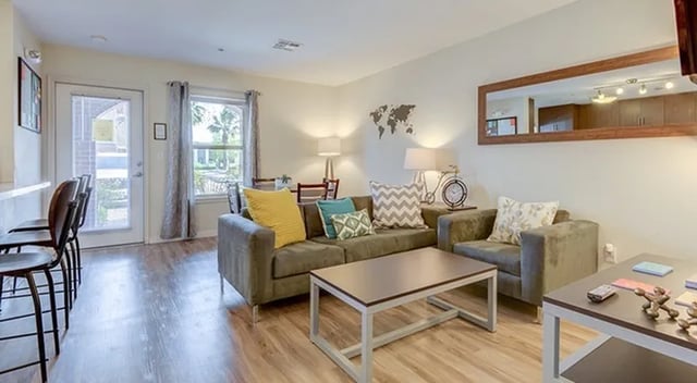 Sofa chairs coffee table and stools Living Room at The U Apartments in Davis Student Accommodation