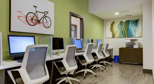 Computers and chairs in a study area at The U Apartments in Davis Student Accommodation