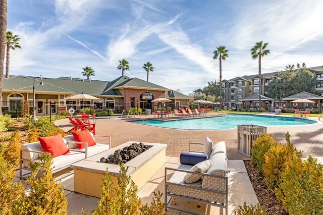 Outdoor lounge seating pool and resort exterior at The U Apartments in Davis Student Accommodation