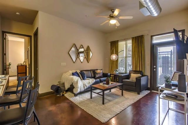 Black sofa rug mirrors living room at Crimson in Tuscaloosa Student Accommodation