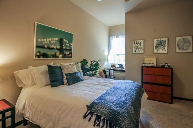 Bed with blue throw dresser and desk bedroom at Crimson in Tuscaloosa Student Accommodation