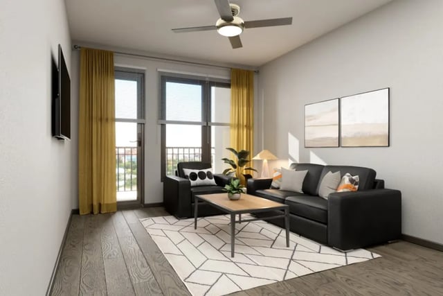 Black couches coffee table rug living room at Crimson in Tuscaloosa Student Accommodation