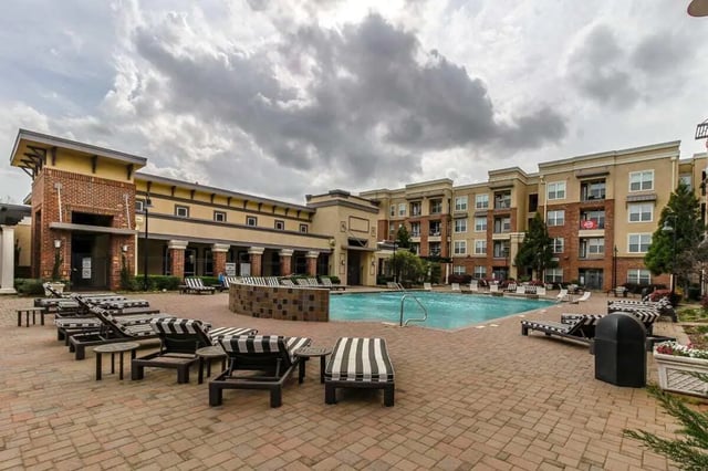 Apartment complex pool with lounge chairs exterior at Crimson in Tuscaloosa Student Accommodation