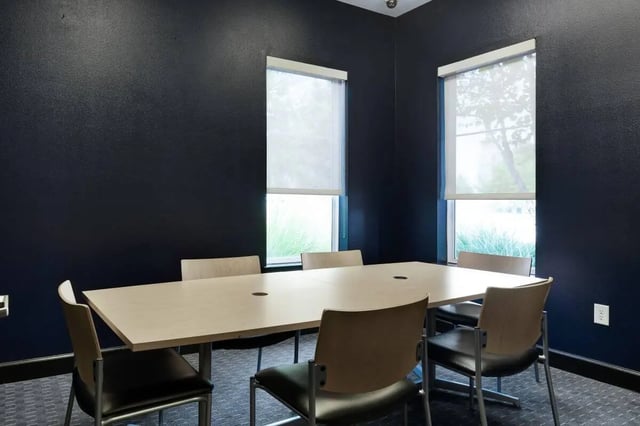 Table and chairs around large table conference room at Crimson in Tuscaloosa Student Accommodation