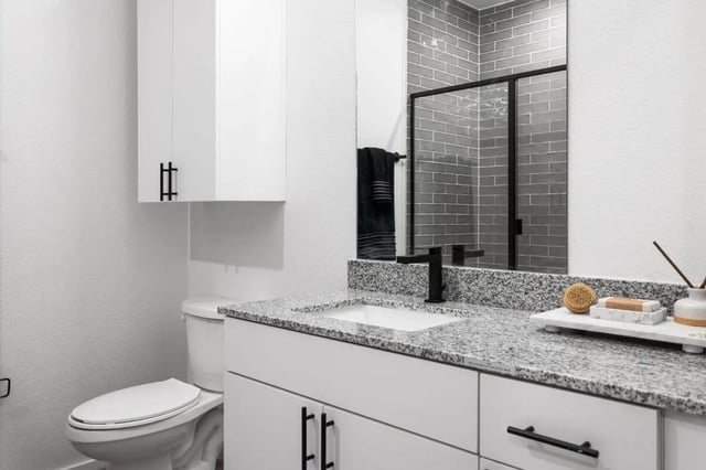 Toilet vanity and shower with grey tiles bathroom at UNITi Bishop Arts in Dallas Student Accommodation