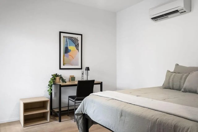 Bed desk plant and artwork study bedroom at UNITi Bishop Arts in Dallas Student Accommodation