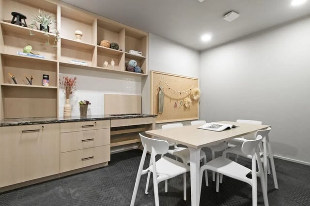 Shelving table chairs and pegboard community room at UNITi Bishop Arts in Dallas Student Accommodation