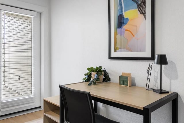 Desk with chair plant and artwork study area at UNITi Bishop Arts in Dallas Student Accommodation
