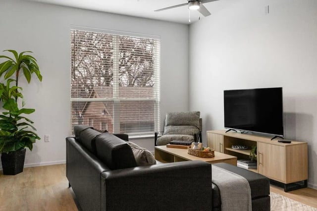 Sofa chair coffee table television living room at UNITi Bishop Arts in Dallas Student Accommodation