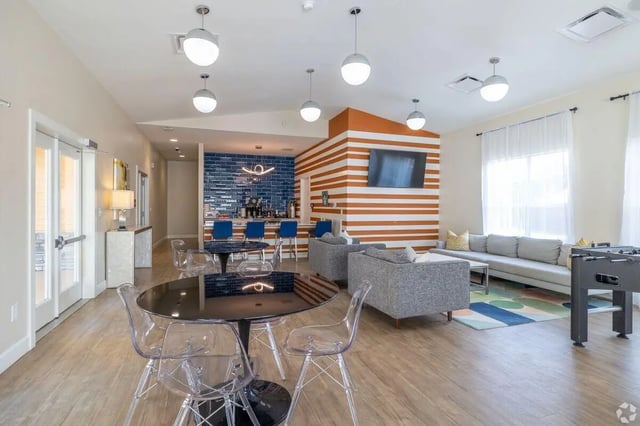 Modern lounge with bar seating and foosball table Living room at Clemson Edge in Clemson Student Accommodation