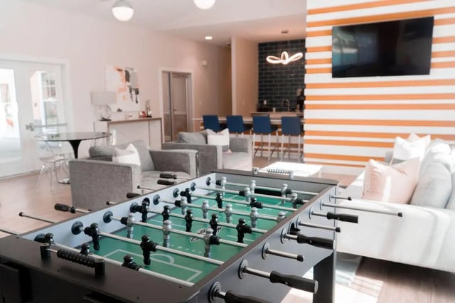 Foosball table sofas chairs bar area living room at Clemson Edge in Clemson Student Accommodation