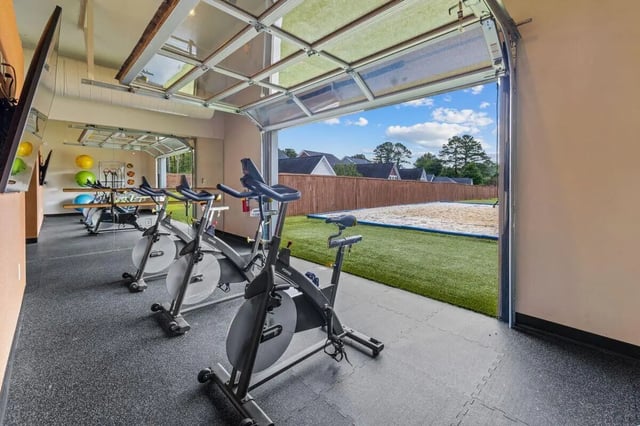 Spinning bikes exercise room with outdoor sand court at Clemson Edge in Clemson Student Accommodation