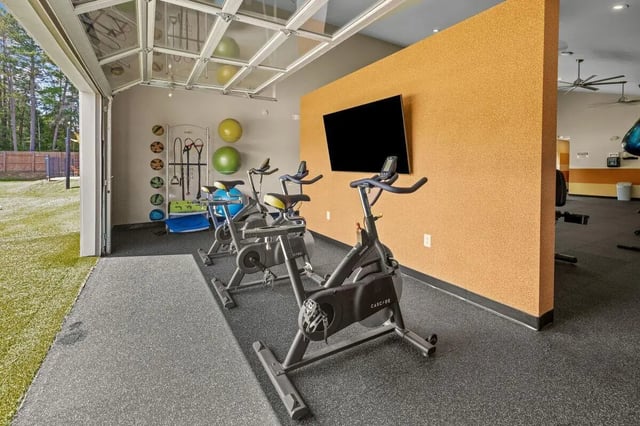 Spin bikes exercise equipment and large TV gym at Clemson Edge in Clemson Student Accommodation