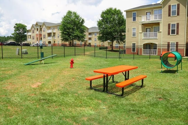Orange picnic table and dog agility tunnel exterior at Clemson Edge in Clemson Student Accommodation