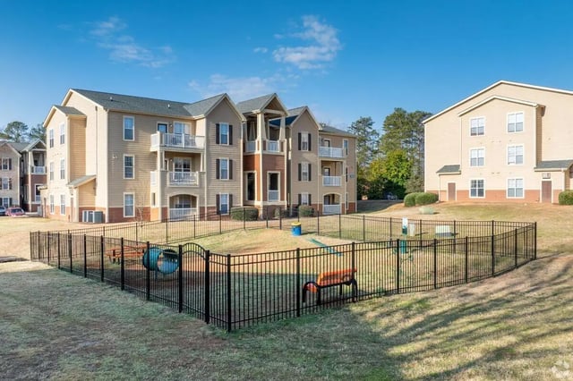 Fenced dog park with play structures exterior at Clemson Edge in Clemson Student Accommodation