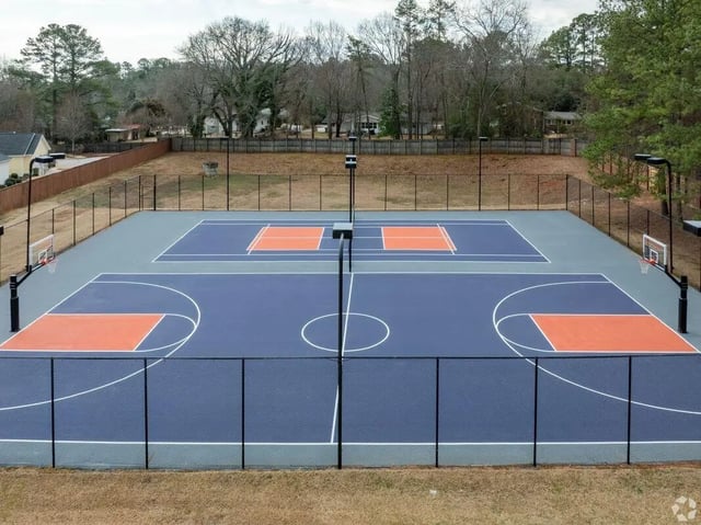 Multi-court sports facility with basketball hoops exterior at Clemson Edge in Clemson Student Accommodation