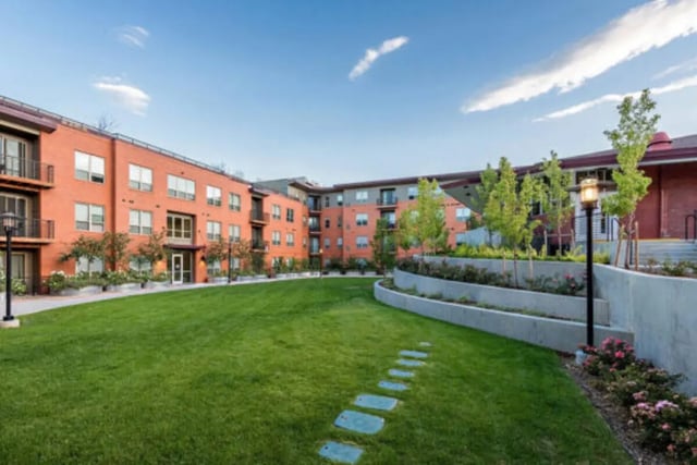 Courtyard with lawn, pathway, and apartments exterior at The Province Boulder in Boulder Student Accommodation