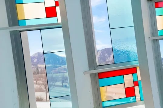 Colorful stained glass windows with mountain view exterior at The Province Boulder in Boulder Student Accommodation