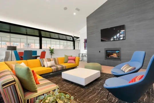 Sectional sofa coffee table fireplace modern living room at The Province Boulder in Boulder Student Accommodation