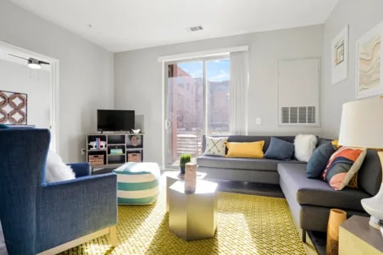 Dark gray sectional sofa with colorful pillows living room at The Province Boulder in Boulder Student Accommodation