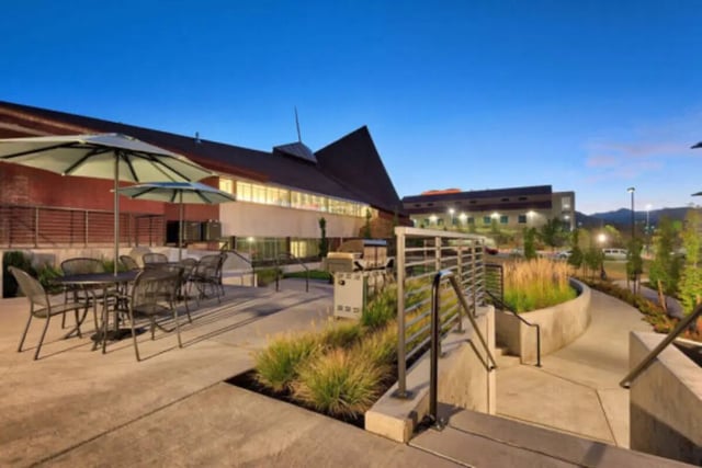 Outdoor seating area with grill and landscaped patio area at The Province Boulder in Boulder Student Accommodation