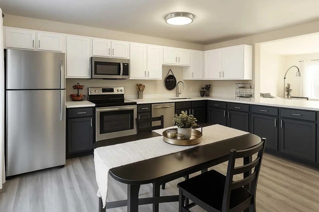 Stainless steel appliances table chairs potted plant kitchen at Copper Beech at Ames Apartments in Ames Student Accommodation
