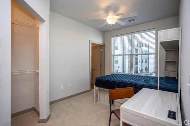 Closet bed desk and shelves bedroom at The Davy in Knoxville Student Accommodation