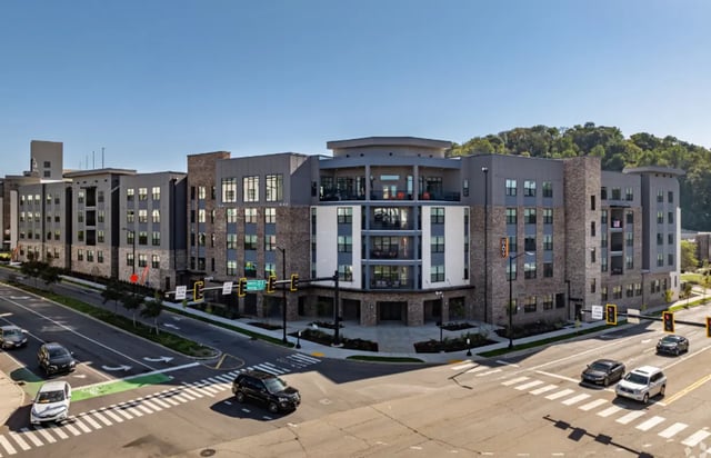 Modern apartment building with balconies cars street exterior at The Davy in Knoxville Student Accommodation