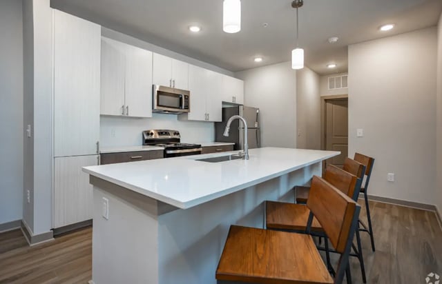 Modern kitchen with island bar stools and stainless steel appliances Kitchen at The Davy in Knoxville Student Accommodation