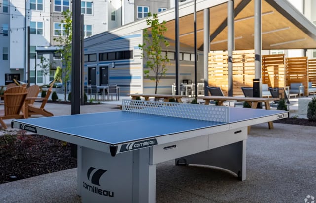 Ping pong table with seating areas outdoors playing area at The Davy in Knoxville Student Accommodation