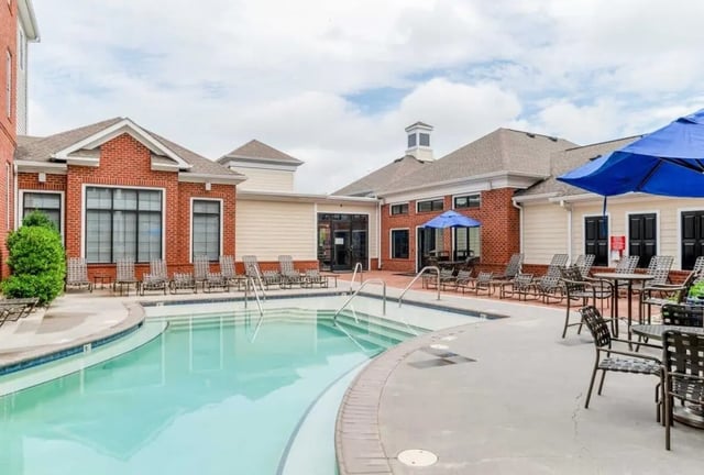 Pool with lounge chairs and umbrellas exterior at The Province Greensboro in Greensboro Student Accommodation