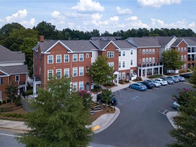 Apartment complex with red brick and white siding exterior at The Province Greensboro in Greensboro Student Accommodation