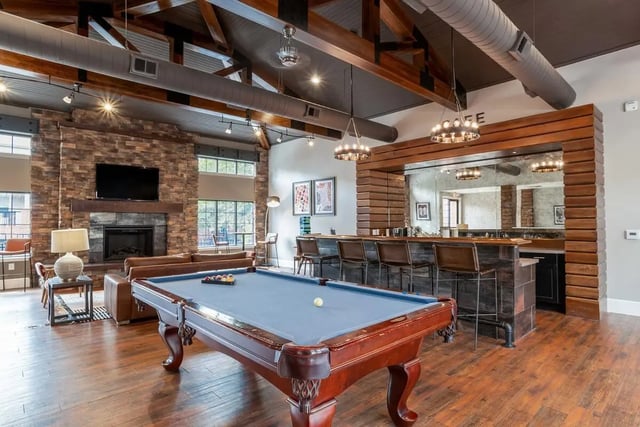 Pool table bar with stools and fireplace living room at The Province Greensboro in Greensboro Student Accommodation