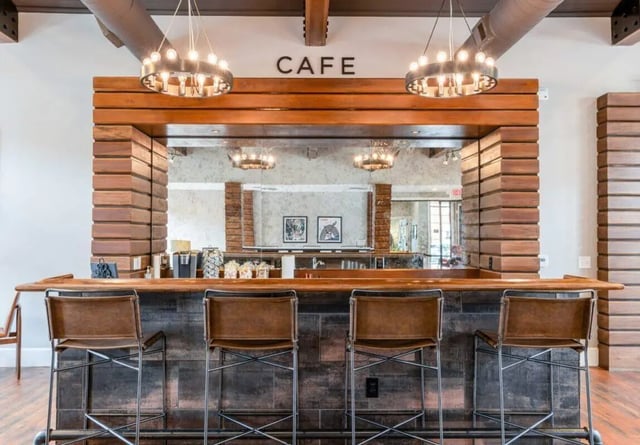 Bar with leather stools and cafe sign lounge at The Province Greensboro in Greensboro Student Accommodation