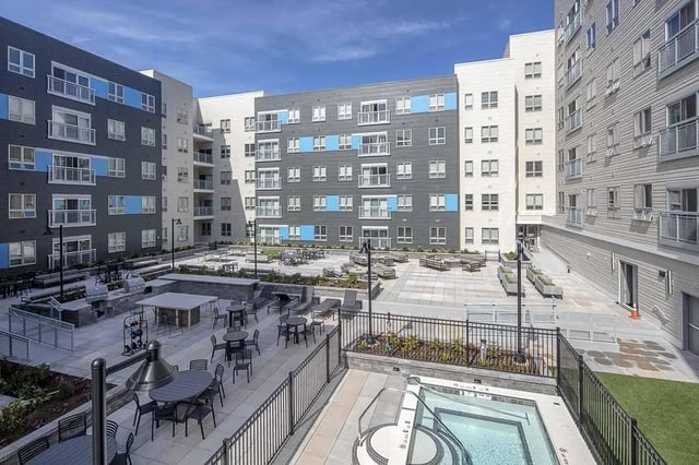 Apartment buildings with courtyards grills hot tubs exterior at Theory Syracuse in Syracuse Student Accommodation