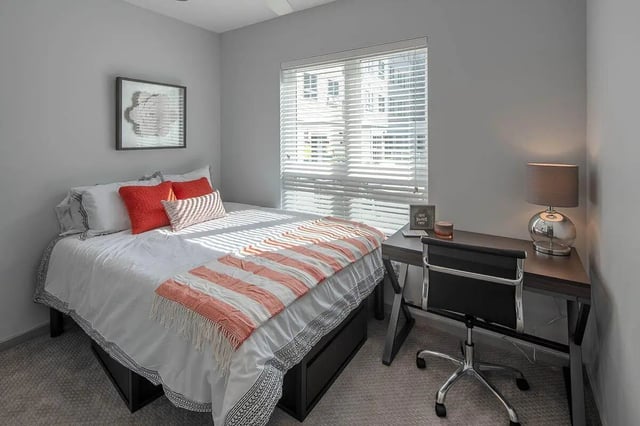 Bed desk chair lamp artwork and blinds bedroom at Theory Syracuse in Syracuse Student Accommodation