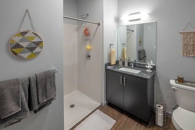 Shower vanity sink toilet and towels bathroom at Theory Syracuse in Syracuse Student Accommodation