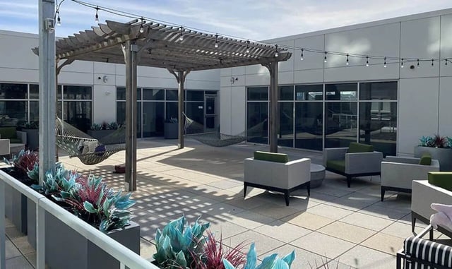 Hammocks under pergola with outdoor seating exterior at Theory Syracuse in Syracuse Student Accommodation