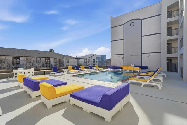 Pool with lounge chairs and seating area exterior at Altitude Baton Rouge | Apartment Complex in Baton Rouge Student Accommodation